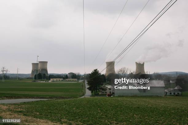Cooling towers at the Exelon Corp. Three Mile Island nuclear power plant stand behind a farm in the neighborhood of Londonderry Township near...