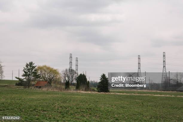 High-tension power lines stand on a farm near the Exelon Corp. Three Mile Island nuclear power plant in the neighborhood of Londonderry Township near...