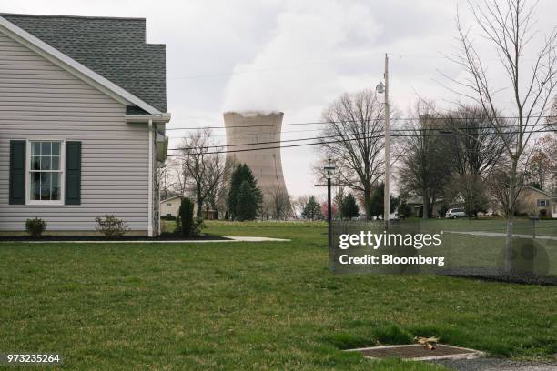 Cooling tower at the Exelon Corp. Three Mile Island nuclear power plant stands behind residential homes in the neighborhood of Londonderry Township...