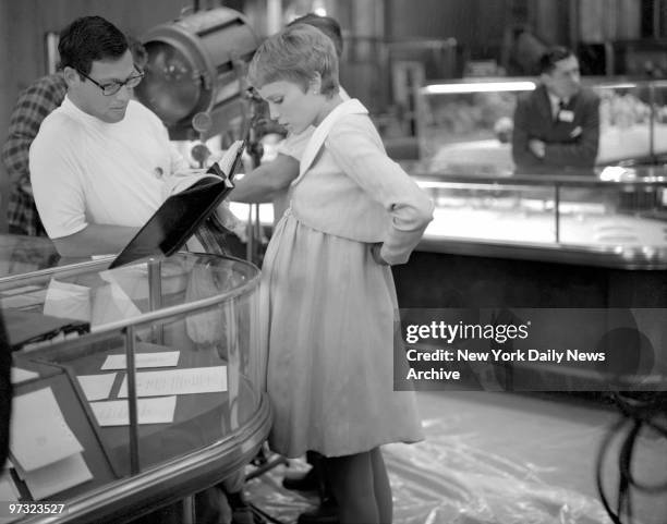 Mia Catches Camera's Eye On Fifth Ave., Mia Farrow, who plays a woman about to have a baby, goes over her lines with script man inside Tiffany's. The...