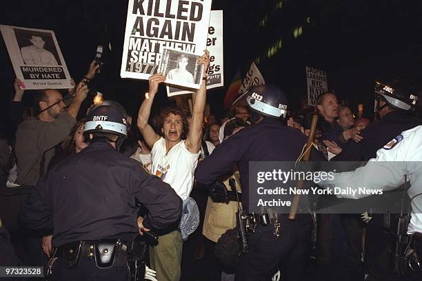 Demonstrators protest hate killing of gay student Matthew Shepard.