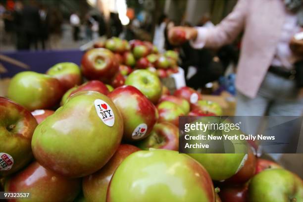 New Yorkers grab complimentary "I Love New York" stickered apples outside Grand Central Terminal where Gov. Eliot Spitzer announced the state's...