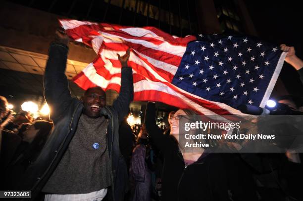 New Yorkers react as Obama is announced the winner as they watch television on a large super screen November 4, 2008 in front of the Adam Clayton...