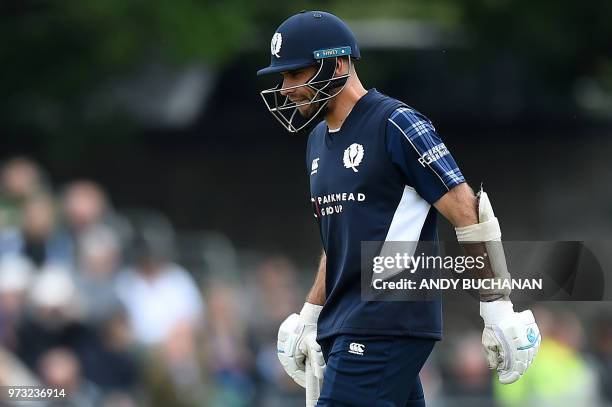 Scotland's captain Kyle Coetzer walks back to the pavilion after losing his wicket for one run during the second Twenty20 International cricket match...