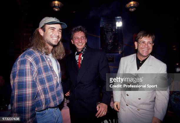 Andre Agassi of the USA with singers Barry Manilow and Elton John at the ATP Players' Awards Party during the ATP Tour World Championships at Planet...
