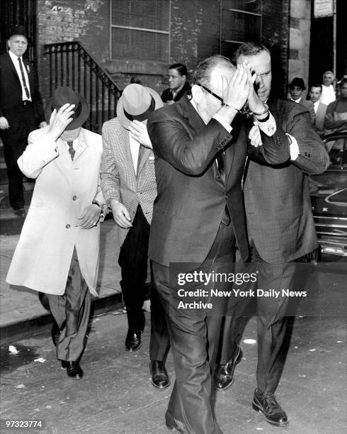 Handcuffed Santo Trafficante , Mike Miranda and 12 other mobsters are arrested in a raid at La Stella Restaurant in Forest Hills, Queens as they...