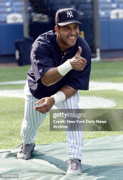 Newly acquired outfielder Raul Mondesi gives his thumbs-up to being dealt to the New York Yankees from Toronto prior to a game against Cleveland...