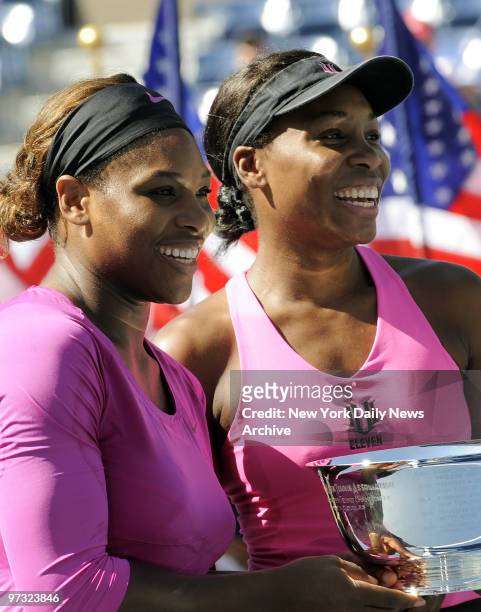 Open 2009 Womens Doubles Finals: Holding winners Trophy Cup Serena Williams and Venus Williams defeat Cara Black and Liezel Huber.