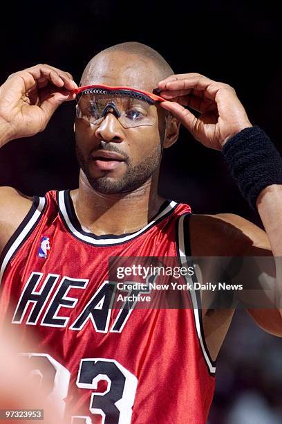 Miami Heat's Alonzo Mourning adjusts glasses in game against the New York Knicks at Madison Square Garden.