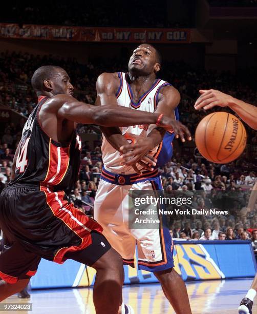 Miami Heat's Anthony Mason blocks a shot taken by New York Knicks' Larry Johnson during action at Madison Square Garden. The Heat went on to beat the...