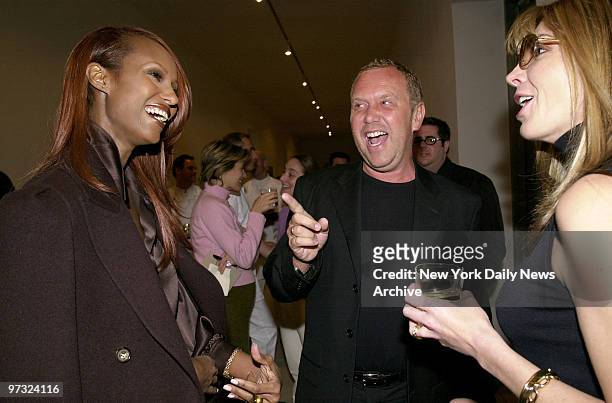 Designer Michael Kors draws smiles from model Iman and actress Natasha Richardson at a luncheon showing of his Celine spring collection at the Ace...