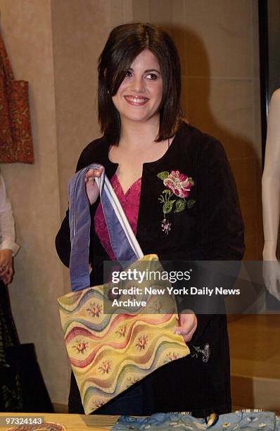 Designer Monica Lewinsky shows one of the handbags in her new collection, on sale at Henri Bendel.