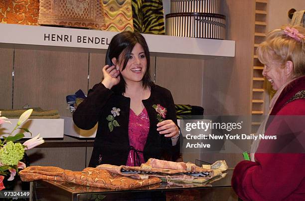 Designer Monica Lewinsky shows some of the handbags in her new collection to a cusstomer at Henri Bendel.