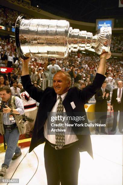 Devils coach Jacques Lemaire with Stanley Cup after Devils beat Detroit.