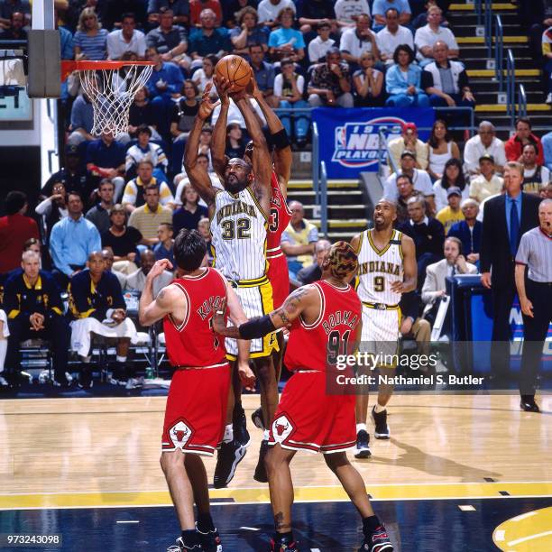 Dale Davis of the Indiana Pacers and Scottie Pippen of the Chicago Bulls rebound during a game played on May 25, 1998 at the Market Square Arena in...