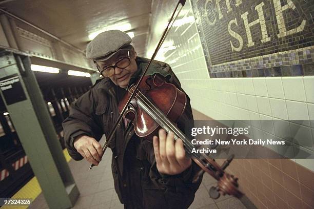 Subway violinist, John Arms, plays in the Christopher Street-Sheridan Square station.