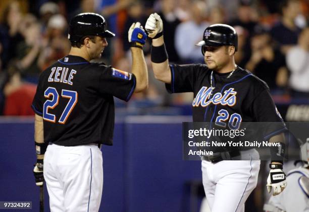 Karim Garcia is congratulated by Todd Zeile after hitting a solo homer in the third inning of a game against the Montreal Expos at Shea Stadium. The...