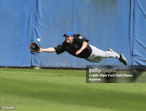 Karim Garcia flies through the air with the greatest of ease in pursuit of a fly ball at the New York Mets' spring training camp in Port St. Lucie,...