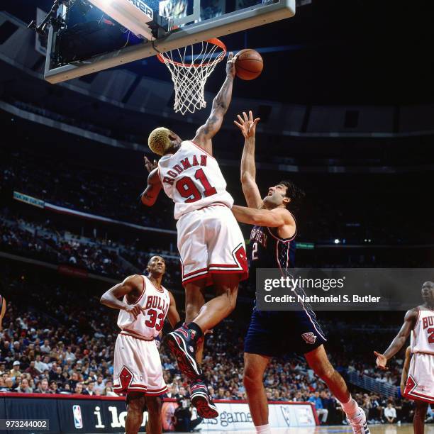 David Benoit of the New Jersey Nets defends Dennis Rodman of the Chicago Bulls during a game played on April 26, 1998 at the United Center in...