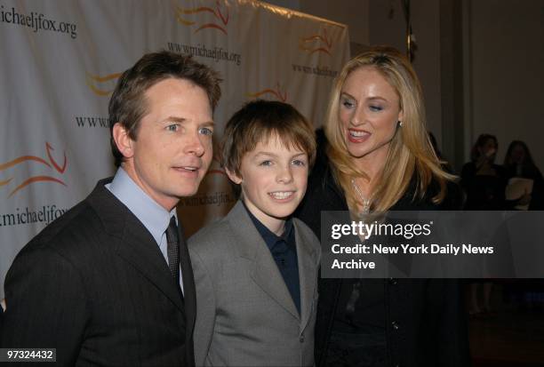 Michael J. Fox and wife Tracy Pollan flank their son, Sam, at "A Funny Thing Happened on the Way to Cure Parkinson's...," an evening of comedy at the...