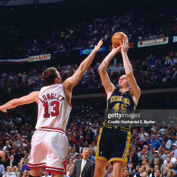 Luc Longley of the Chicago Bulls defends Rik Smits of the Indiana Pacers during a game played on May 31, 1998 at the United Center in Chicago,...