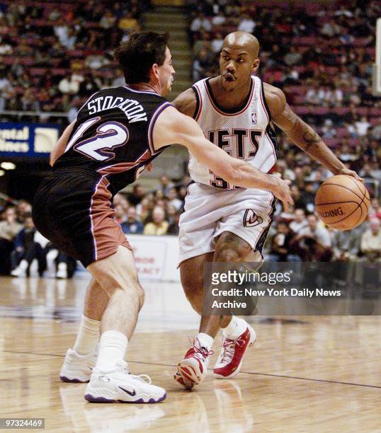 Utah Jazz' John Stockton takes a swipe at the ball while guarding New Jersey Nets' Stephon Marbury during action at Continental Airlines Arena....