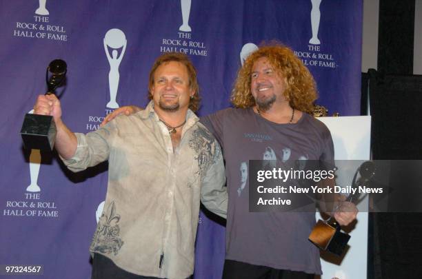 Michael Anthony and Sammy Hagar of Van Halen clutch their statuettes as they take the stage in the press room at the Waldorf Astoria hotel during the...