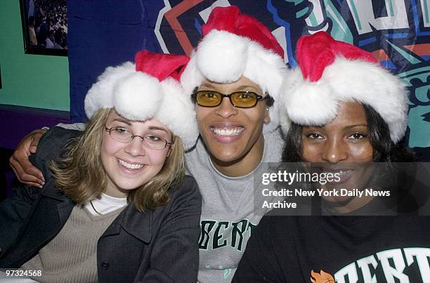 New York Liberty players Becky Hammon, Teresa Weatherspoon and Kym Hampton show they are team players at the first annual Toys for Tots at Cafe 31.