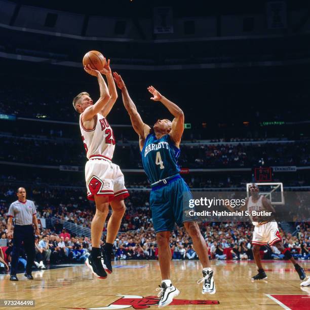 Steve Kerr of the Chicago Bulls shoots over David Wesley of the Charlotte Hornets during a game played on May 13, 1998 at the United Center in...