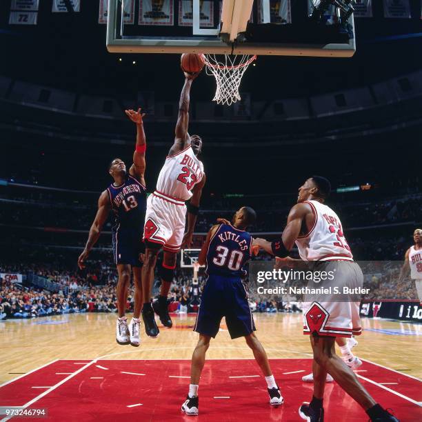 Michael Jordan of the Chicago Bulls dunks against the New Jersey Nets during a game played on April 26, 1998 at the United Center in Chicago,...