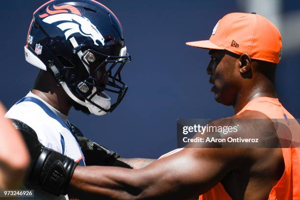 Former Denver Broncos linebacker Demarcus Ware speaks to Von Miller during the team's mandatory minicamp on Wednesday, June 13, 2018.