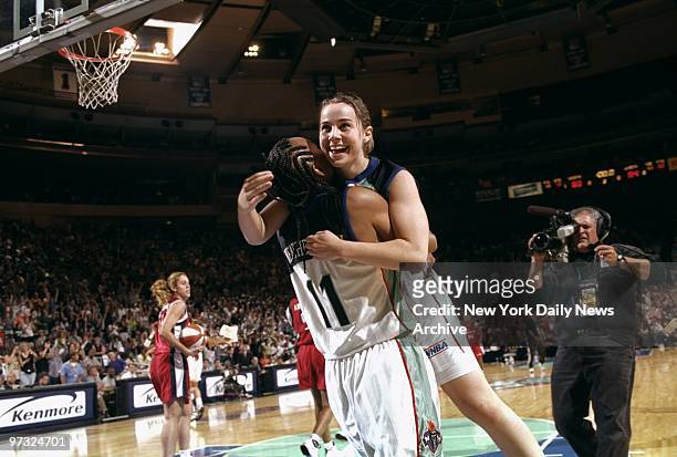 New York Liberty's Teresa Weatherspoon celebrates with Becky Hammon after a 69-64 win over the Houston Comets at Madison Square Garden.