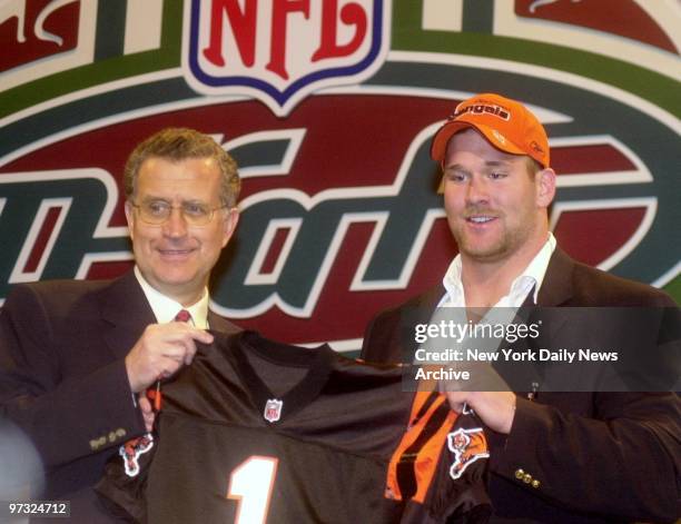 Commissioner Paul Taglibue holds a Cincinnati Bengals' jersey with No. 3 pick, defensive end Justin Smith, during the NFL draft at Madison Square...