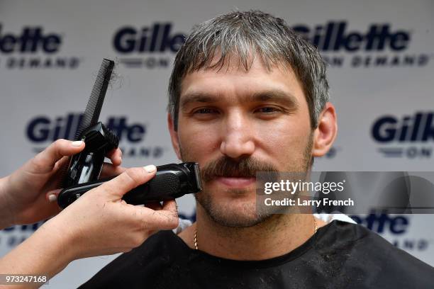 With the help of a barber, World Champion hockey star Alex Ovechkin gets his "playoff beard" trimmed down with a clipper before completing his...