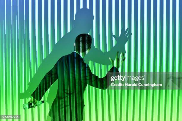 Visitor gestures as he interacts with the artwork of Carlos Cruz-Diez "Translucent Chromointerferent Environment" during the press preview for Art...