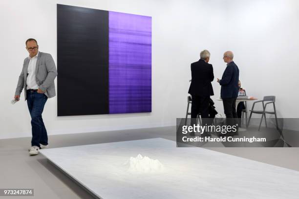 Visitors speak in the gallery Kerlin during the press preview for Art Basel at Basel Messe on June 13, 2018 in Basel, Switzerland. Art Basel is one...