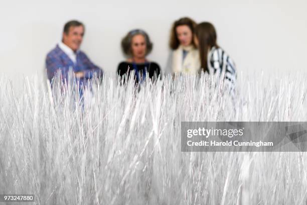 Visitors look at the artwork of Lee Ufan "Relatum" during the press preview for Art Basel at Basel Messe on June 13, 2018 in Basel, Switzerland. Art...
