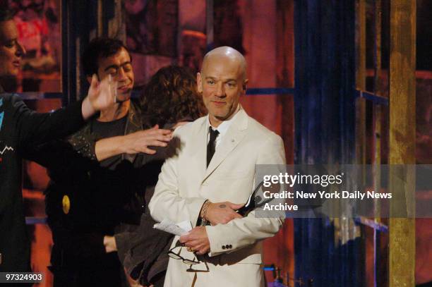 Michael Stipe holds his statuette onstage at the Waldorf Astoria hotel as he and REM band mates Peter Buck, Bill Berry and Mike Mills are inducted...