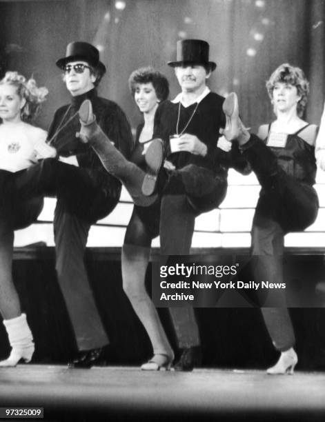 Michael Caine and Charles Bronson kick up their heels with the Rockettes during "Night of 100 Stars" at Radio City Music Hall.