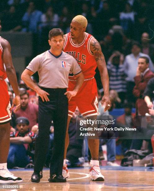 Dennis Rodman confronts referee Ted Bernhardt after receiving second technical foul during game against New Jersey Nets.