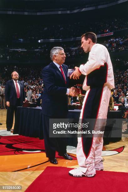 Commissioner David Stern presents Jud Buechler of the Chicago Bulls with a championship ring during a game played on November 1, 1997 at the First...