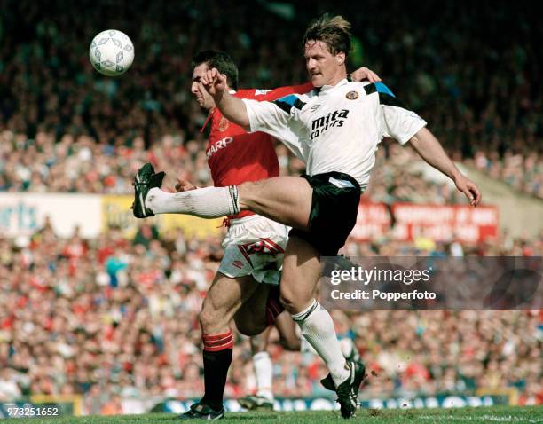 Eric Cantona of Manchester United and Shaun Teale of Aston Villa in action during an FA Premier League match at Old Trafford on March 14, 1993 in...