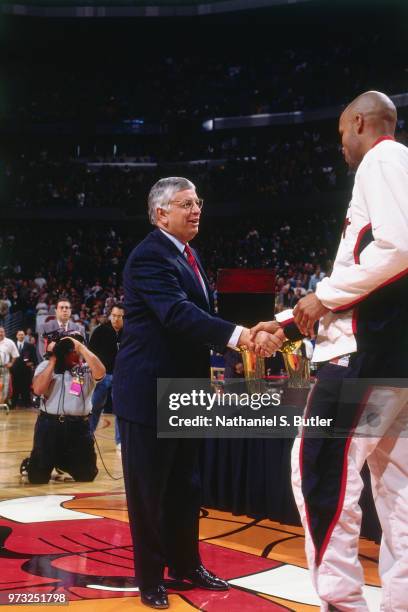Commissioner David Stern presents Ron Harper of the Chicago Bulls with a championship ring during a game played on November 1, 1997 at the First...