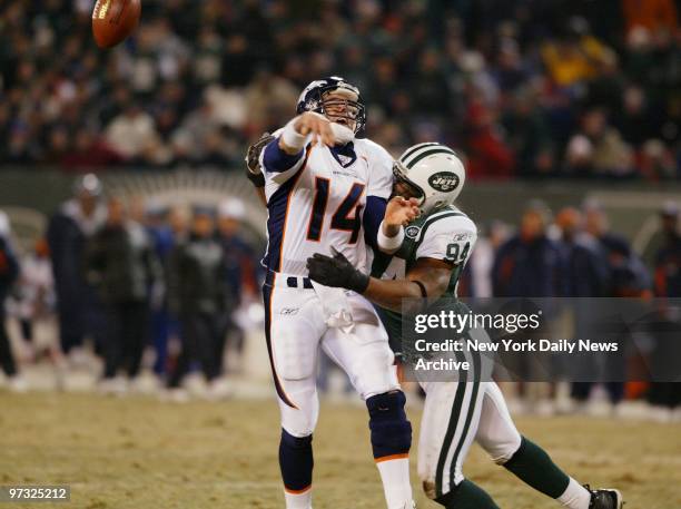 Denver Broncos' quarterback Brian Griese is hit hard by New York Jets' John Abraham during game action at Giants' Stadium. The Jets went on to win,...