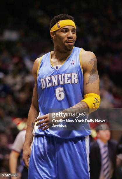 Denver Nuggets' Kenyon Martin smiles while on the floor of Continental Airlines Arena as he takes on his former team, the New Jersey Nets. The game...