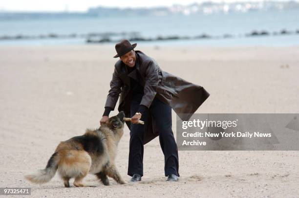 Denzel Washington plays with his dog on the beach at Coney Island where he is filming scenes for his new movie "American Gangster."