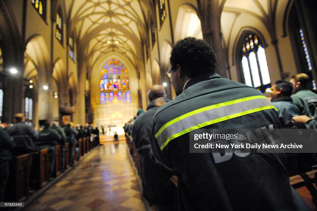 Department of Sanitation workers attend a memorial service a