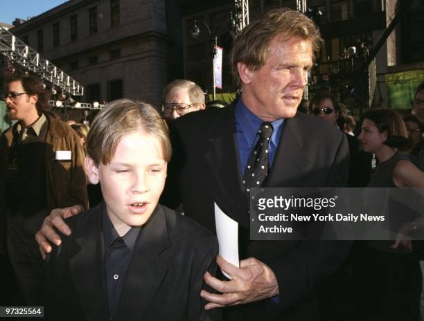Nick Nolte guides his son Brawley through the crowd on arrival at premiere of the movie "Godzilla" at Madison Square Garden.