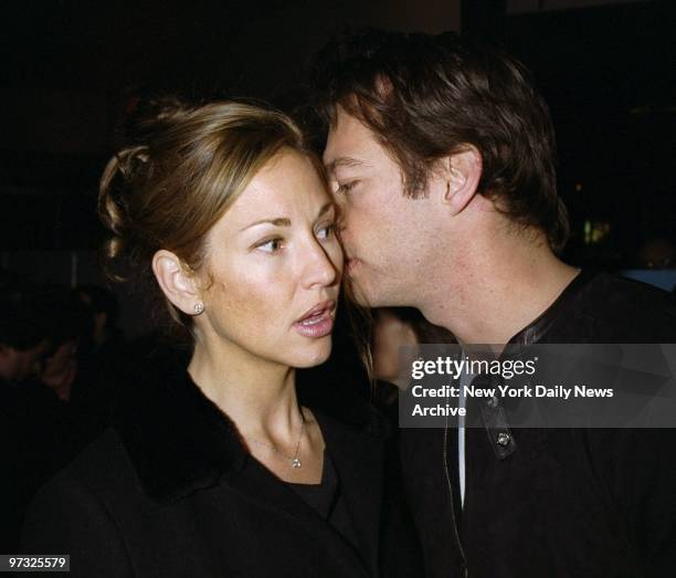 Supermodel Jill Goodacre lends an ear to the whispering of her husband, Harry Connick Jr., at the premiere screening of the TV movie "Rodgers and...