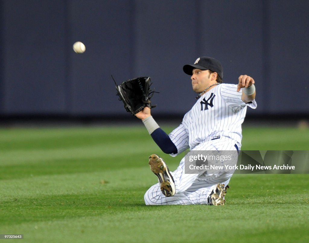 Nick Swisher makes a sliding catch in the 9th inning of game